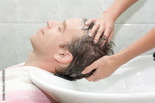 Photo: blonde in a salon getting washed her hair with shampoo blonde in a salon getting washed her hair with shampoo