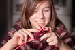 Cute girl knitting with needles and yarn
