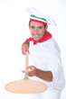 Pizza chef with a wooden peel