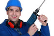 Tradesman holding up an electric screwdriver