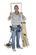 craftsman holding a window frame