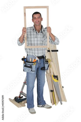 Photo: craftsman holding a window frame craftsman holding a window frame