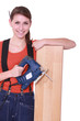 Photo: Woman laying wood flooring Woman laying wood flooring
