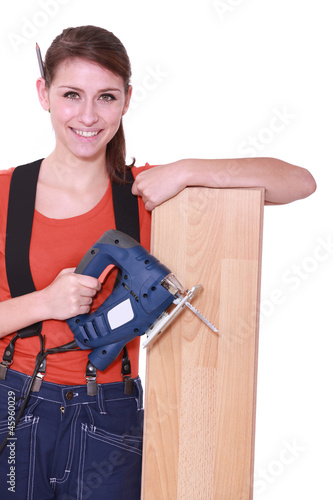 Photo: Woman laying wood flooring Woman laying wood flooring