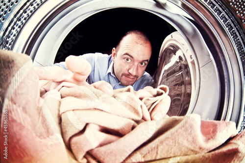 Photo: man and washing machine man and washing machine