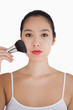 Woman using powder brush