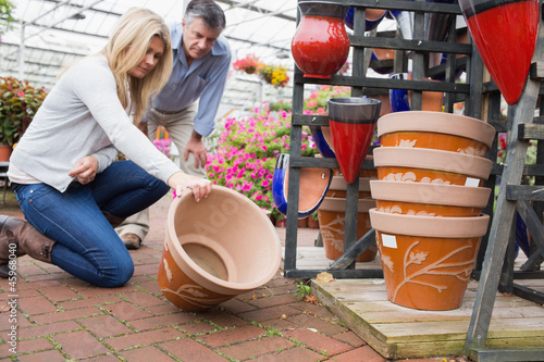 Photo: Couple looking at a pot Couple looking at a pot