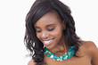 Woman smiling and wearing necklace