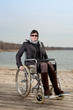 Woman with suitcase wheelchair and walk on the road