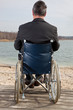 Man with suitcase wheelchair and walk on the road
