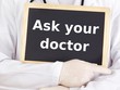Doctor shows information on blackboard: ask your doctor