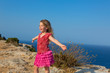 blue day with kid girl open hands to the wind