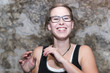 Candid photograph of a young woman in glasses laughing