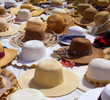 Photo: Hats display on a street market outdoor Hats display on a street market outdoor