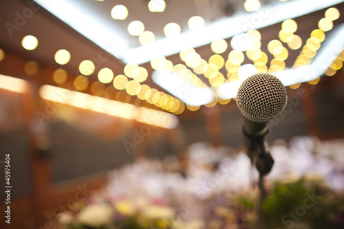 Photo: Close up of microphone in concert hall or conference room Close up of microphone in concert hall or conference room