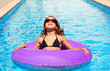 bikini girl with sunglasses and inflatable pool ring