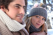 Young man and young woman wearing wool cap