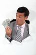 happy businessman holding dollars
