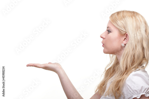 Photo: beautiful young woman blowing a kiss beautiful young woman blowing a kiss