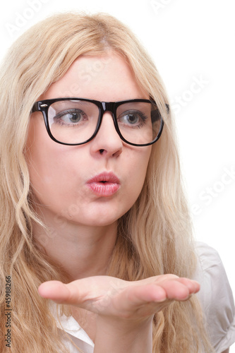 Photo: beautiful young woman blowing a kiss beautiful young woman blowing a kiss