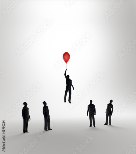 Photo: Tiny abstract man flying away on a balloon Tiny abstract man flying away on a balloon