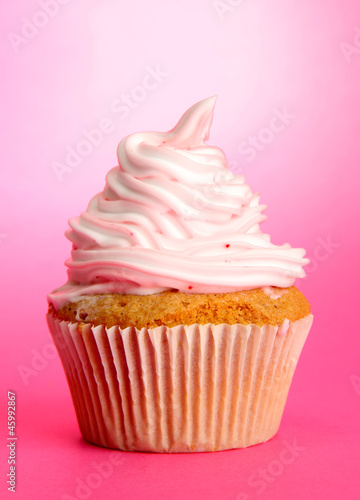 Photo: tasty cupcake, on pink background tasty cupcake, on pink background