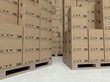 Cardboard boxes on wooden paletts, inside the warehouse
