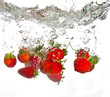 Strawberries falling into water