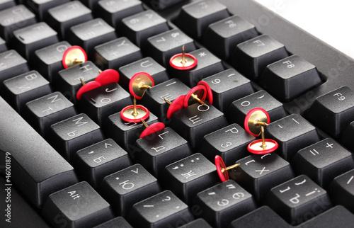 Photo: Painful typing, pins on keyboard close-up Painful typing, pins on keyboard close-up