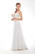 Photo: Bride in white couture wedding dress with flowers posing Bride in white couture wedding dress with flowers posing