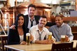 Happy friends drinking beer at pub