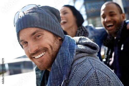 Photo: Happy young man in hat and scarf Happy young man in hat and scarf