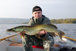 Photo: Happy angler with pike fishing trophy Happy angler with pike fishing trophy