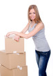 Young and beautiful smiling woman with boxes
