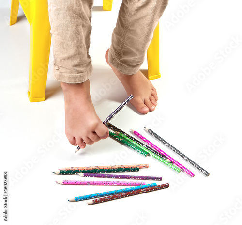 Photo: Child's feet performing gymnastic with pencils Child's feet performing gymnastic with pencils