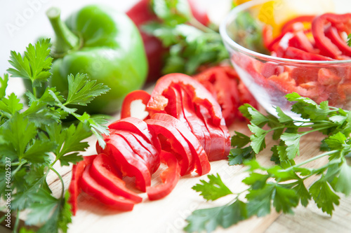 Photo: Fresh raw peppers sliced and whole. ripe vegetables Fresh raw peppers sliced and whole. ripe vegetables