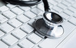 Close up of stethoscope on pc keyboard. Health concept