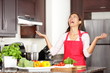 Sad housewife crying while cooking