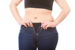 Size 40 woman zipping jeans, obesity and overweight concept