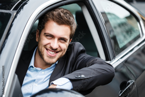 Photo: Handsome man driving his car Handsome man driving his car