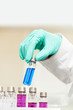 hand in glove with flask test at pharmacy lab