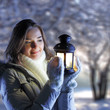 beautiful girl on winter forest with lantern