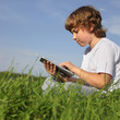 Boy with tablet pc outdoors
