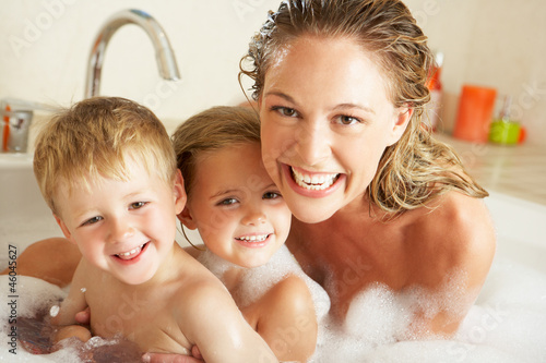 Photo: Mother With Children Relaxing In Bubble Filled Bath Mother With Children Relaxing In Bubble Filled Bath