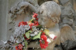 angelic sculpture with flowers , detail of historic tomb