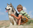 Boy hugging a fluffy dog