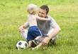 father playing football with his son