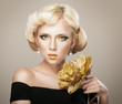 Beautiful woman face with luxury gold makeup