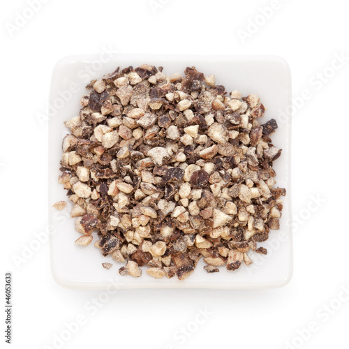 Photo: Crushed Black pepper (Piper nigrum) in a white bowl on white bac Crushed Black pepper (Piper nigrum) in a white bowl on white bac
