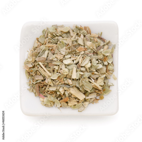 Photo: Ground dried Basil (Sweet Basil) in a white bowl on white backgr Ground dried Basil (Sweet Basil) in a white bowl on white backgr